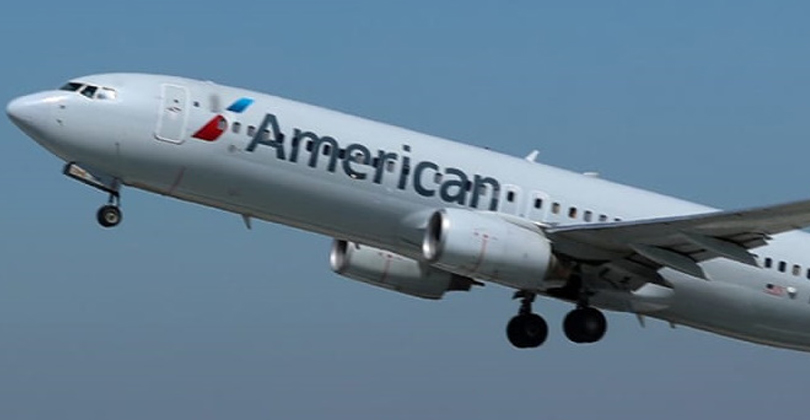 Picture of an American Airlines airplane returning patients home after having dental work at Frontline Dental CR in San Jose, Costa Rica.  The airplane is ascending and shows American Airlines new colors.